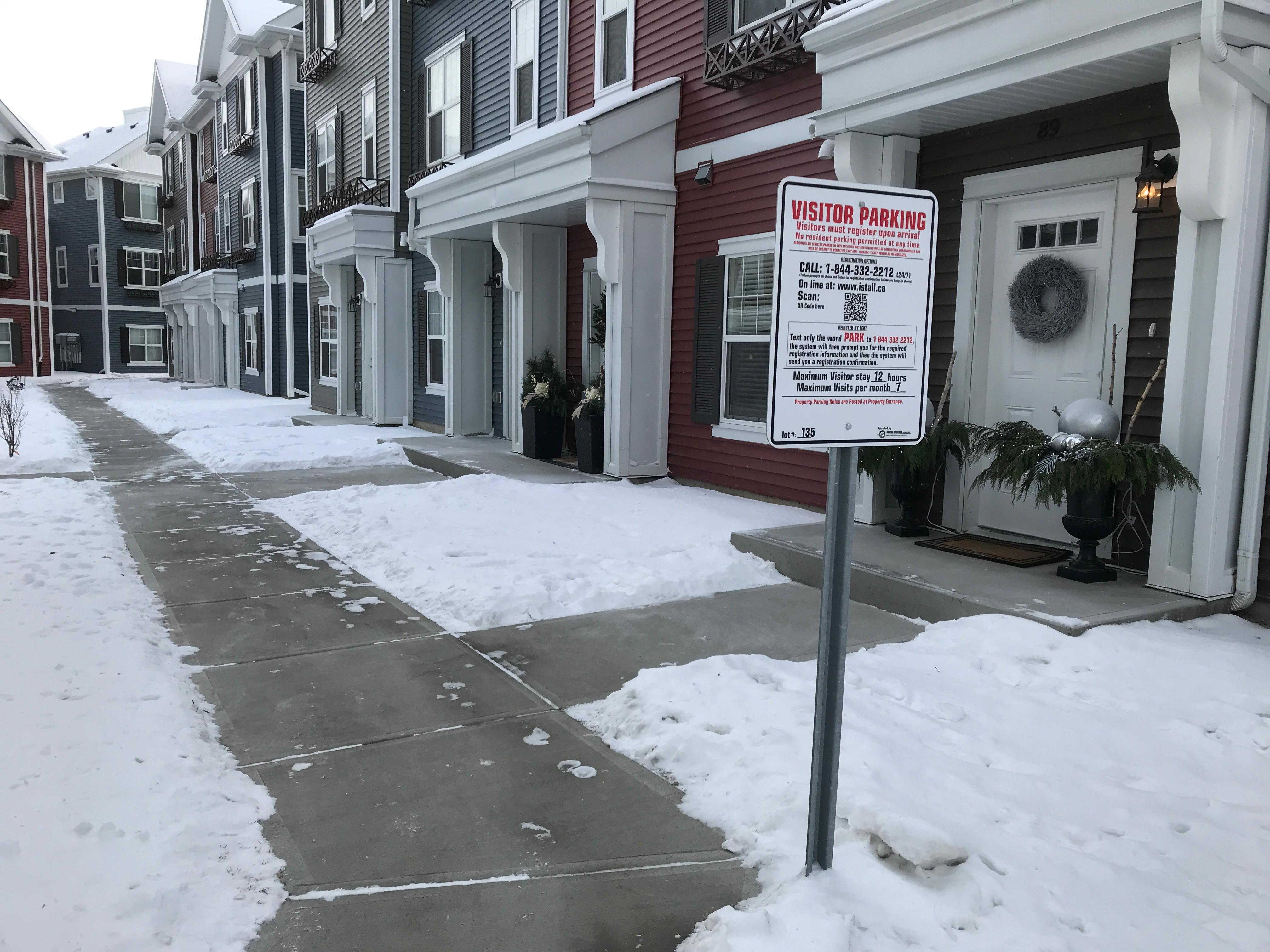 Townhouse row with cleared walkways in courtyard area in winter conditions